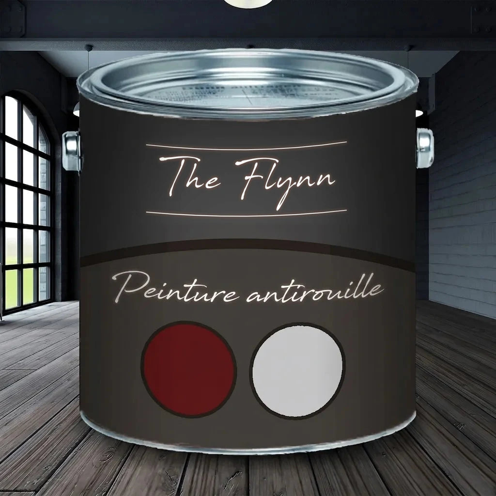 Pot de peinture antirouille The Flynn, couleurs rouge foncé et gris clair, sur plancher en bois dans pièce industrielle.